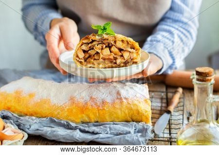 Apple Strudel From The Oven. Mint Strudel.the Cook Makes The Cake.housewife Is Preparing An Apple Pi