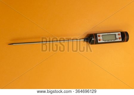 Electronic Meat Thermometer On An Orange Background .