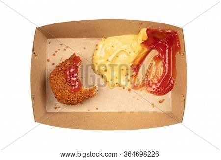 Partly Eaten Brown Crusty Dutch Kroket With Mustard And Ketchup Isolated On A White Background