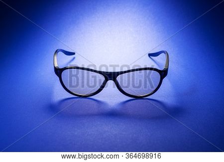 3D Glasses For Watching Movies On A Blue Background