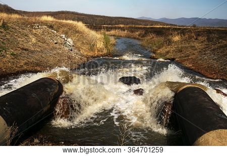 Discharge Of Waste Water Into The River. Violation Of Environmental Ecology.