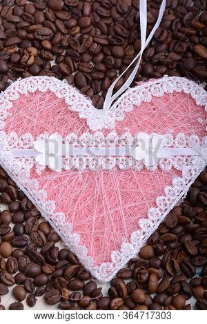Coffee Beans Background And Papper Pink Heart. Close Up