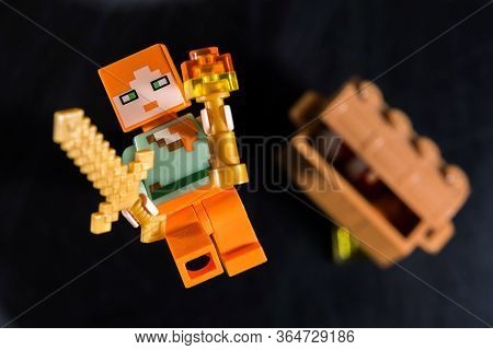 Kiev, Ukraine - May 05, 2020: Minecraft Game Characters Alex Minifigure With A Sword And Torch Falls