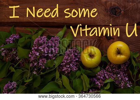 Bright Yellow Apples, Purple Lilac Flowers With Fresh Green Leaves On Wooden Background Flat Lay.col