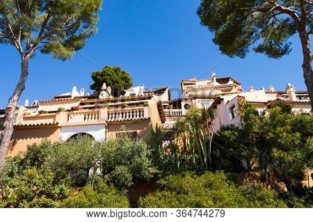 Majorcan Architecture With Constructions On A Hill Between Two Trees