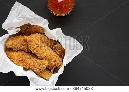 Homemade Chicken Tenders With Sour-sweet Sauce On A Black Background, Top View. Flat Lay, Overhead, 