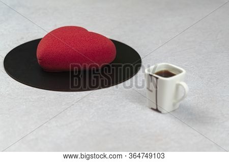 Velours Cake In The Shape Of A Heart And A Cup Of Coffee, Close-up. Modern French Mousse Pastry Dess