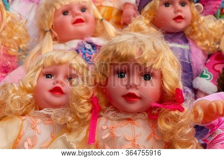 Colourful Tiny Blonde Baby Dolls For Sale At Retail Shop At Christmas Market, New Market Area, Kolka