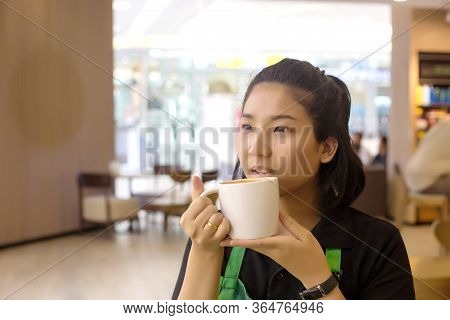 Asian Girl Model Holding Coffee Cup And Drinking On White