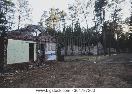 Old Abandoned Soviet Age Camp: Ruined Damaged Buildings In The Forest. Sad, Depressive Post-apocalyp