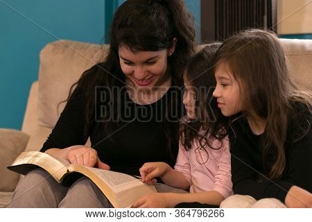 Mother Reading The Bible To Her Children
