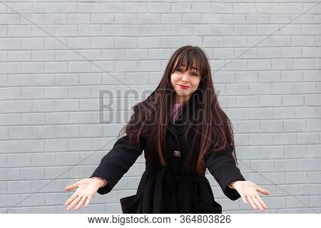 The Beautiful Brunette On The Street In Bewilderment