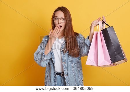 Photo Of Astonished Emotional Lovely Attractrive Young Female Holding Packages With Purchases, Cover