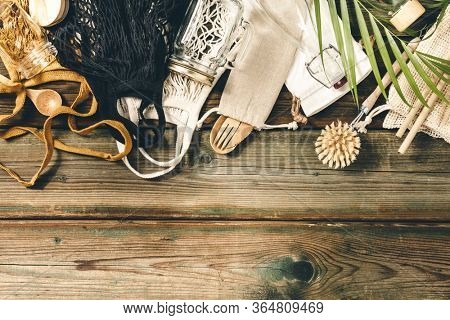 Zero waste concept. Textile eco bags, glass jars, bamboo recycled tableware on wooden background