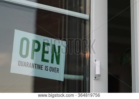 Sign That Says Open On Cafe Or Restaurant Hang On Door At Entrance. Quarantine Is Over.