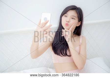 Beautiful Young Asian Woman Sexy In Underwear Talking A Selfie On Smartphone For Social Network In T