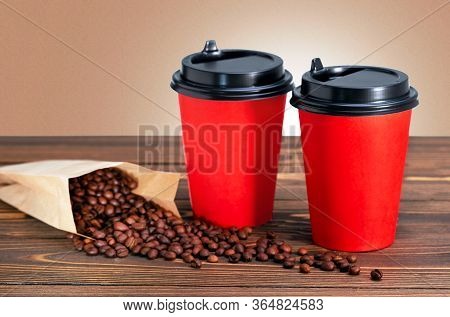 Two Disposable Coffee Cup. Coffee Cup To Go At Wooden Table.