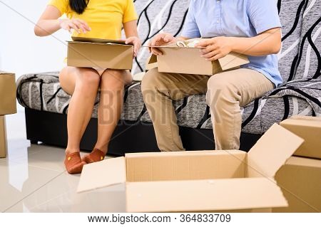Thai Entrepreneur Couple Are Packing. Oline Shopping And Home Delivery. Lock Down And Self-quarantin