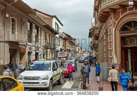 CUENCA, ECUADOR - MAY 07, 2019: Busy urban street with people passing by in the center of Cuenca, colonial town in Ecuador