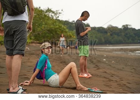 NUQUI, CHOCO, COLOMBIA - APRIL 18, 2019: Beach of the Pacific Ocean with rainforest in Choco, Colombia, people going on a walk and realxing on the sand