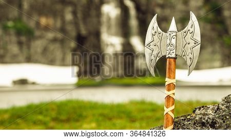 Equipment Of Viking Or Barbarian Warrior Outdoor On Nature. Viking Axe Against Norwegian Nature. Tou