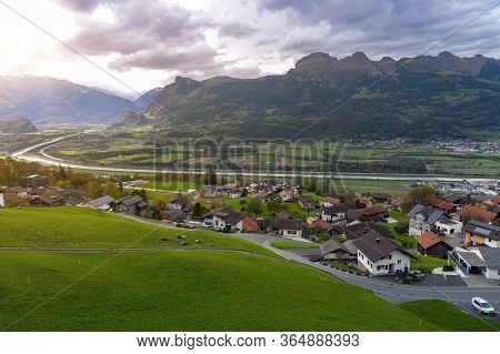 Scenic Aerial View Of Hillside Villages In Triesenberg And The River Rhine, Natural Border Of Liecht