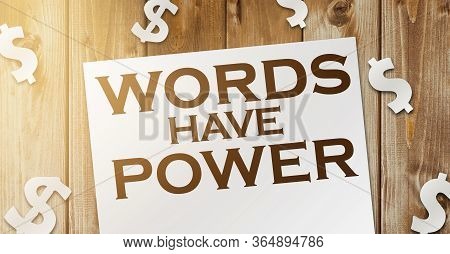 Words Have Power Text On Page And Paper Dollar Signs Around On Wooden Table. Copywritting Storytelli