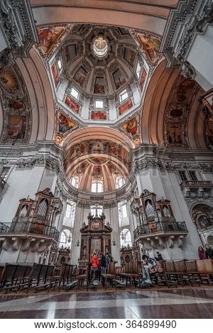 Feb 4, 2020 - Salzburg, Austria: Ultrawide View Of Central Dome With Tourists On The Pews Inside Sal