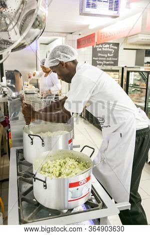 African Male Chef Staff Working In The Kitchen Of Butchery And Deli Section At Local Pick N Pay Groc