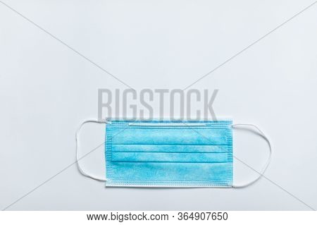 One Blue Protective Medical Mask On A White Background. Copispace