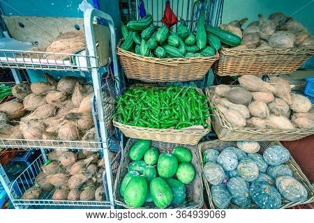 Colorful Vegetable Stall In Little India, Singapore With Luffa Acutangula, Coconut, Acorn Squash