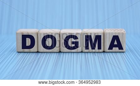 Concept Word Dogma On Cubes On A Striped Blue Background. Business Concept.