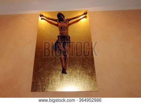 A Jesus Christ Figure Without Cross Hanging On Golden Plate