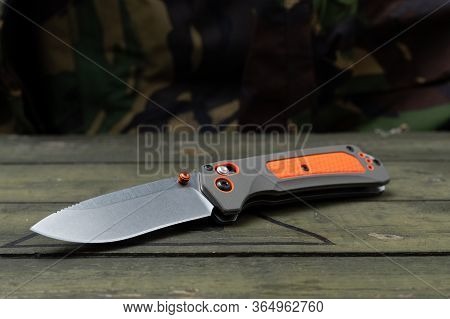Knife For Tourism And Survival. Knife With An Orange Rubber Handle. Military Wooden Box.
