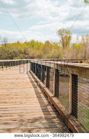 Low Angle View Of A Pedestrain Footbridge In Elm Creek Park Reserve Along The Trails On A Spring Day