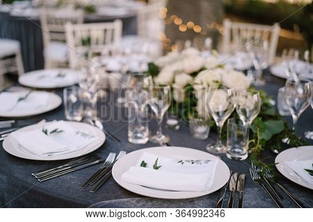 Wedding Dinner Table Reception. White Round Plates On A Round Table With Gray Tablecloth, White Chia