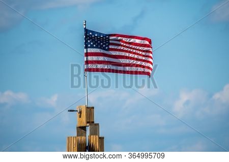 Rockport, Tx, Usa - April 18, 2019: A Us Flag On Top Of A Poll At Rockport Beach
