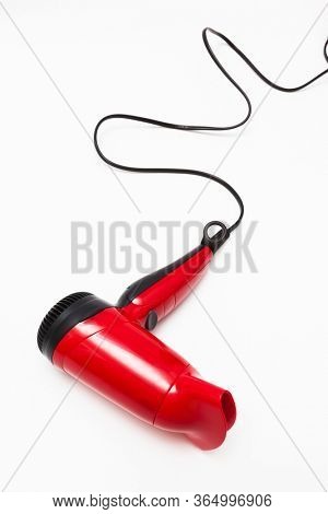 beautiful red hair dryer on a white background