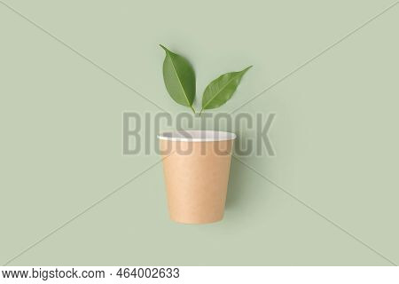 Eco - Friendly Tableware On Green Background. Top View. Plastic Free Set Of Brown Paper Utensil. Str