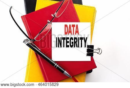 Data Integrity Text Written On Sticky On Colorful Notebooks
