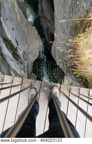 Zillis, Grison, Switzerland, April 12, 2022 Standing On A Small Pedestrian Bridge And Looking Down T