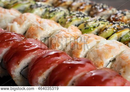Japanese Seafood Sushi Set On Black Background, Close Up. Assorted Sushi. Rainbow Sushi Roll