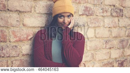 Beautiful Latin American Young Adult Woman With Bobble Hat Outdoor In City In Winter