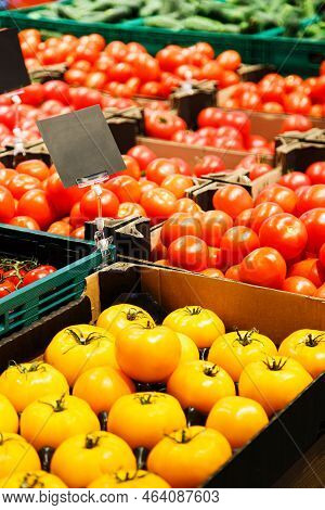 Fresh Colourful Tomatoes In Boxes At Market.