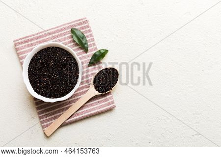 Quinoa Seeds In Bowl And Spoon On Colored Background. Healthy Kinwa In Small Bowl. Healthy Superfood