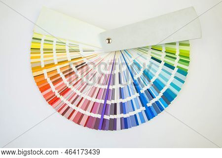 Color Guide Close Up. Assortment Of Colors For Design. Colors Palette Fan On White Concrete Wall Bac