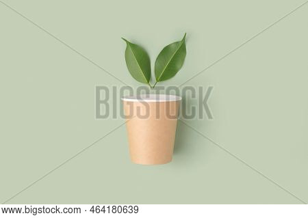 Eco - Friendly Tableware On Green Background. Top View. Plastic Free Set Of Brown Paper Utensil. Str