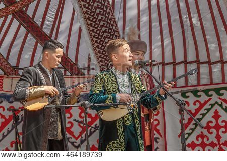 Almaty, Kazakhstan - September 18, 2022. Young Guys In National Kazakh Costumes Sing And Play The Do