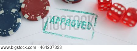Close-up Of Stamp Approved Standing Near Playing Cards And Chips In Casino With Dice. Addiction, Pla