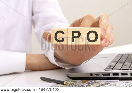 Hand Holds Wooden Cubes With Inscription Cpo - Short For Cost Per Order, White Background